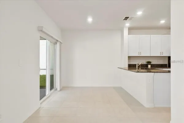 a view of kitchen with stainless steel appliances granite countertop cabinets