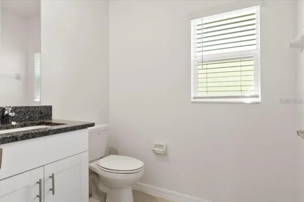 a white toilet sitting next to a white sink