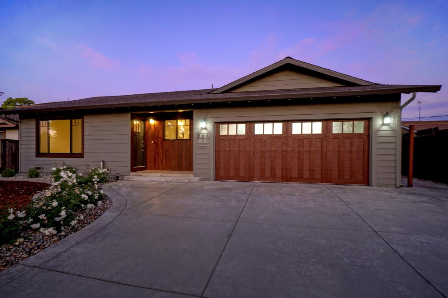 890 Quintinia Drive Sunnyvale, CA 94086 - Photo 1 of 37 a front view of a house with a yard and garage