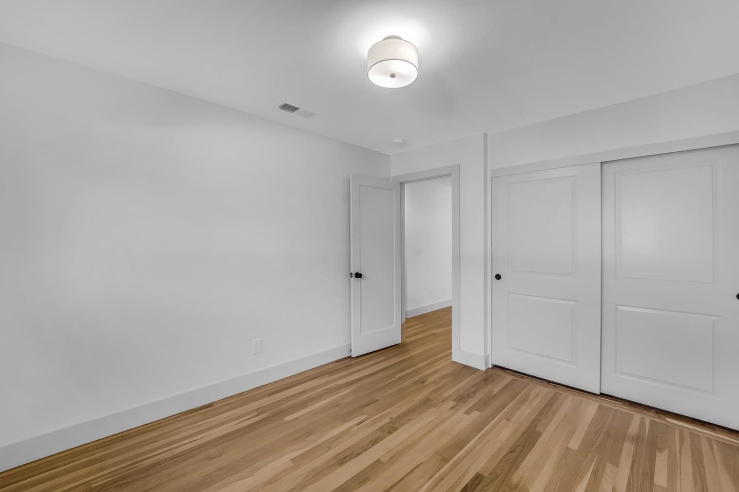 890 Quintinia Drive Sunnyvale, CA 94086 - Photo 20 of 37 a view of an empty room and wooden floor
