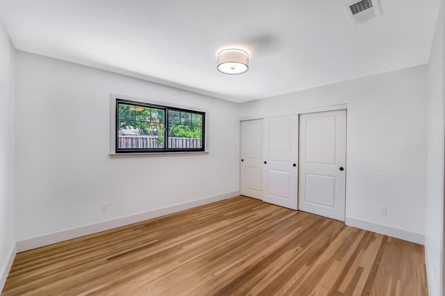 890 Quintinia Drive Sunnyvale, CA 94086 - Photo 22 of 37 a view of a room with wooden floor and window