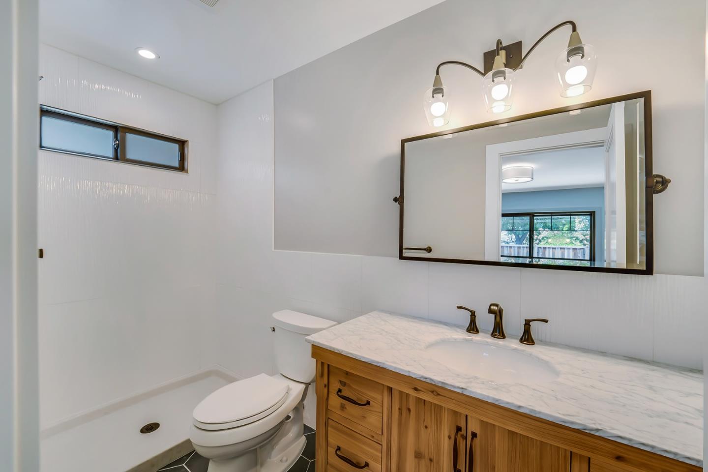 890 Quintinia Drive Sunnyvale, CA 94086 - Photo 26 of 37 a bathroom with a granite countertop toilet sink and mirror