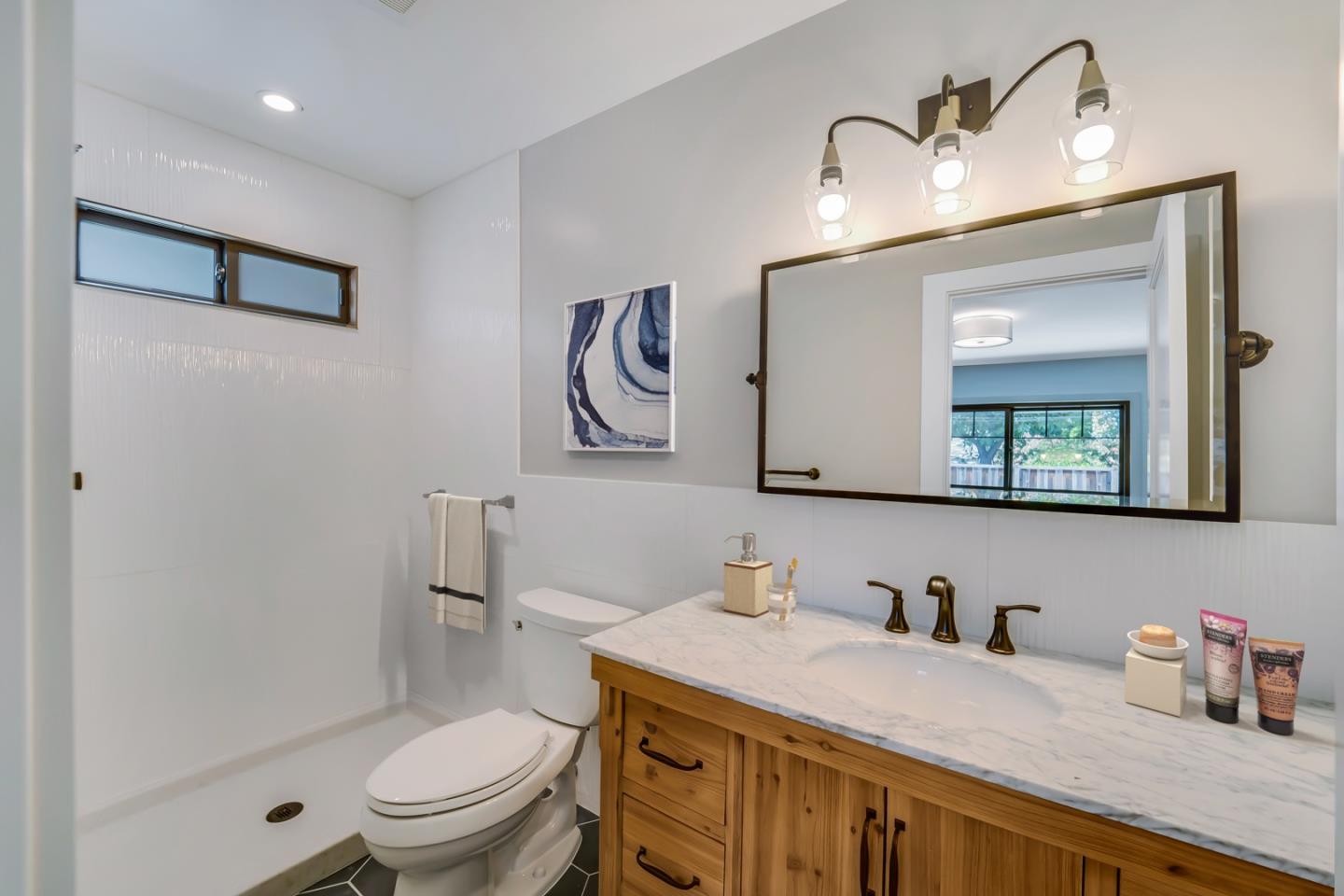 890 Quintinia Drive Sunnyvale, CA 94086 - Photo 27 of 37 a bathroom with a granite countertop toilet sink and mirror