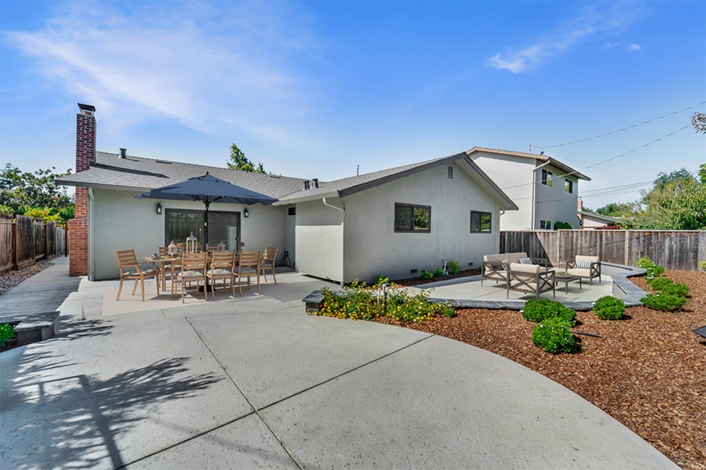 890 Quintinia Drive Sunnyvale, CA 94086 - Photo 30 of 37 a view of a patio with table and chairs under an umbrella with potted plants