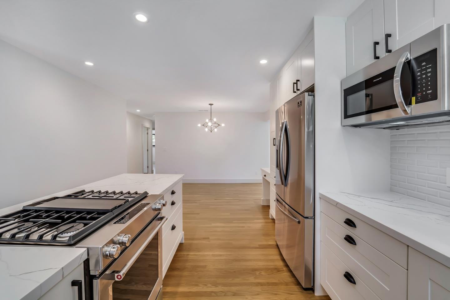 890 Quintinia Drive Sunnyvale, CA 94086 - Photo 7 of 37 a kitchen with stainless steel appliances granite countertop a stove and a refrigerator