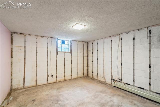 28018 County Farm Road Pueblo, CO 81006 - Photo 25 of 50 Basement with baseboard heating and a textured ceiling