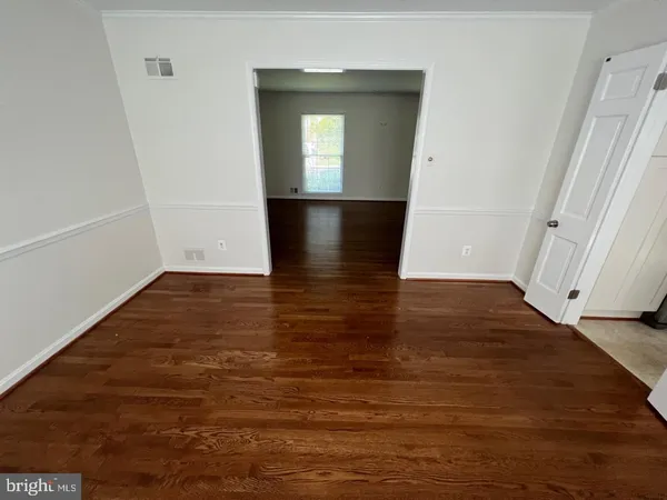 wooden floor in a hall with an empty room