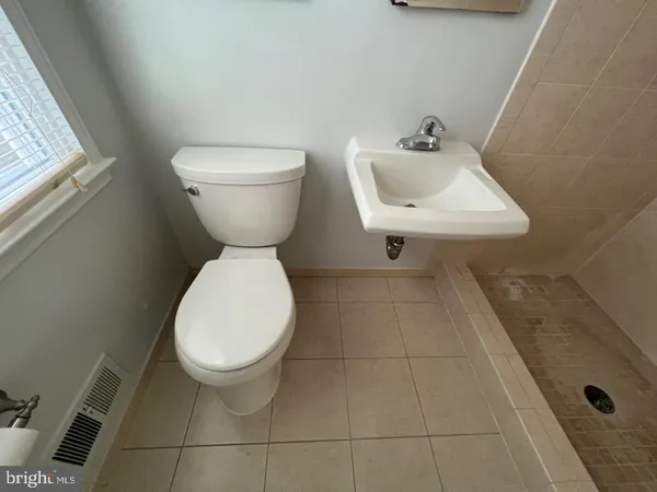 a bathroom with a toilet and a sink