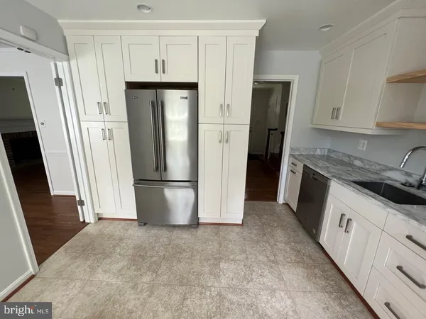 a view of kitchen with refrigerator stove and window