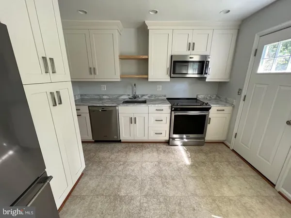 a kitchen with stainless steel appliances granite countertop a stove and a sink