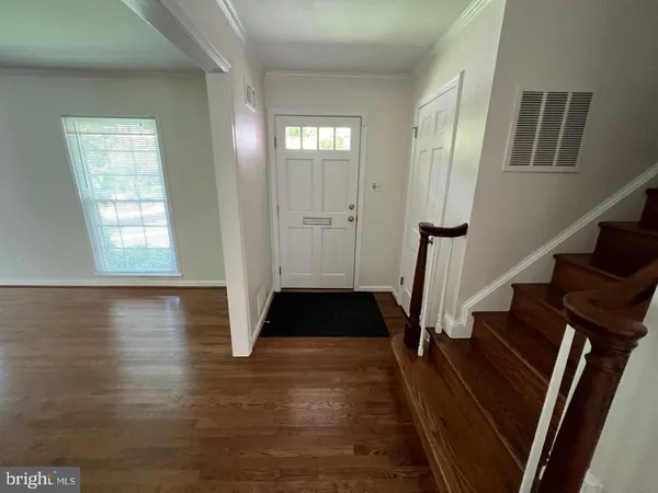 a view of entryway with wooden floor and stairs