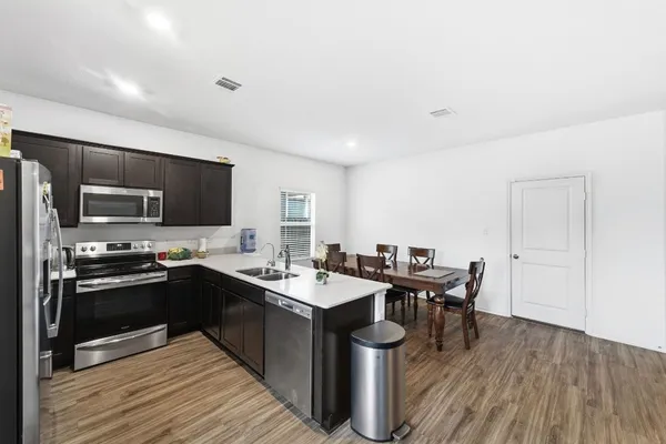 a kitchen with stainless steel appliances granite countertop a sink stove and microwave
