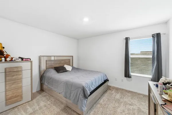 a bedroom with a bed and dresser