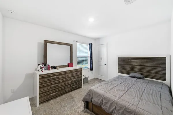 a living room with a bed furniture and a large window