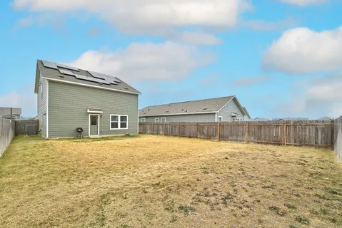 a house view with swimming pool in front of it