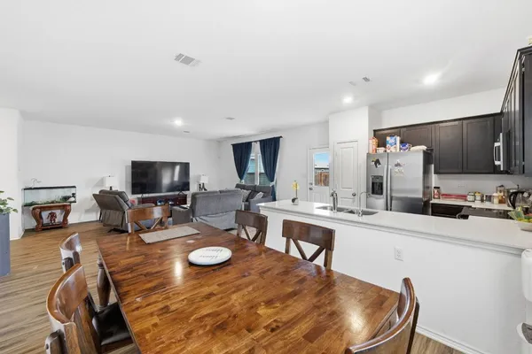 a kitchen with sink a stove and chairs