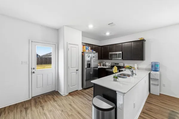 a kitchen with a sink appliances and cabinets