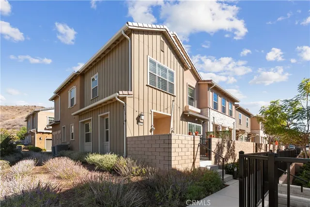 a front view of a residential apartment building with a yard