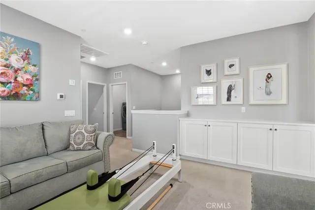 a living room with furniture and wall paintings