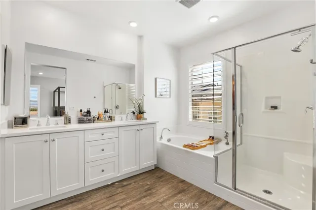 a bathroom with a tub sink shower and mirror