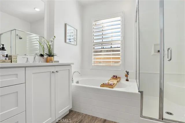 a bathroom with a bathtub sink vanity and mirror