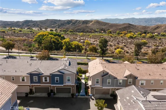 an aerial view of residential houses with outdoor space