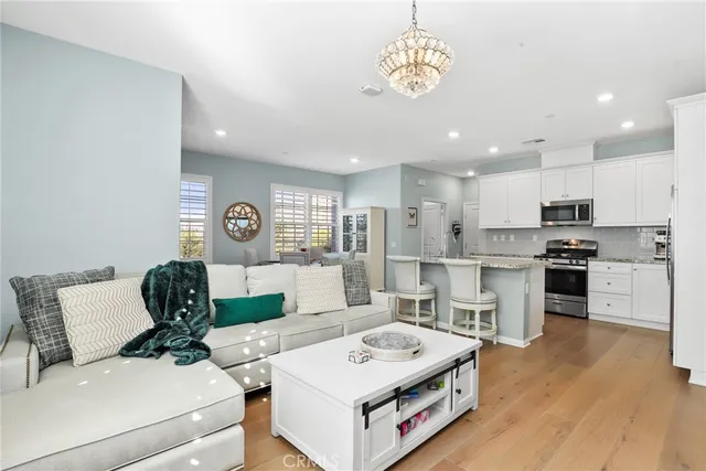 a living room with kitchen island furniture and a wooden floor
