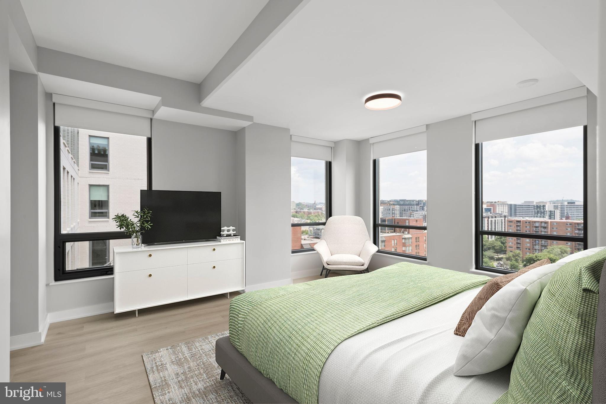 950 3rd Street Northwest, Unit PH1302 Washington, DC 20001 - Photo 25 of 37 a bedroom with a bed and a flat screen tv