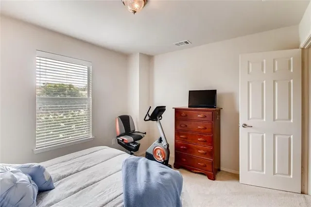 a bedroom with a bed and a television