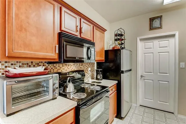 a kitchen with stainless steel appliances granite countertop a stove and a refrigerator