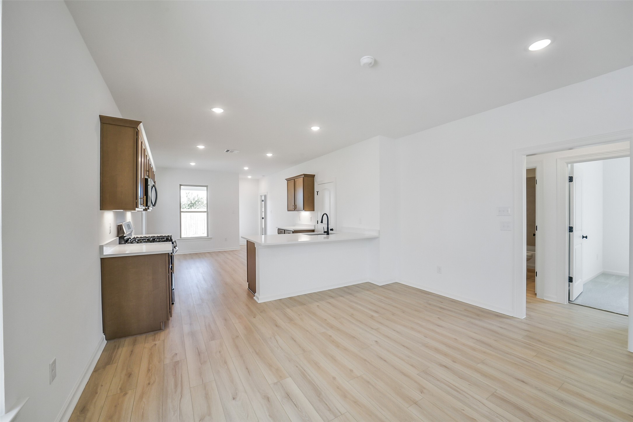 40708 Pessi Road Magnolia, TX 77354 - Photo 11 of 30 a view of kitchen with sink microwave and refrigerator