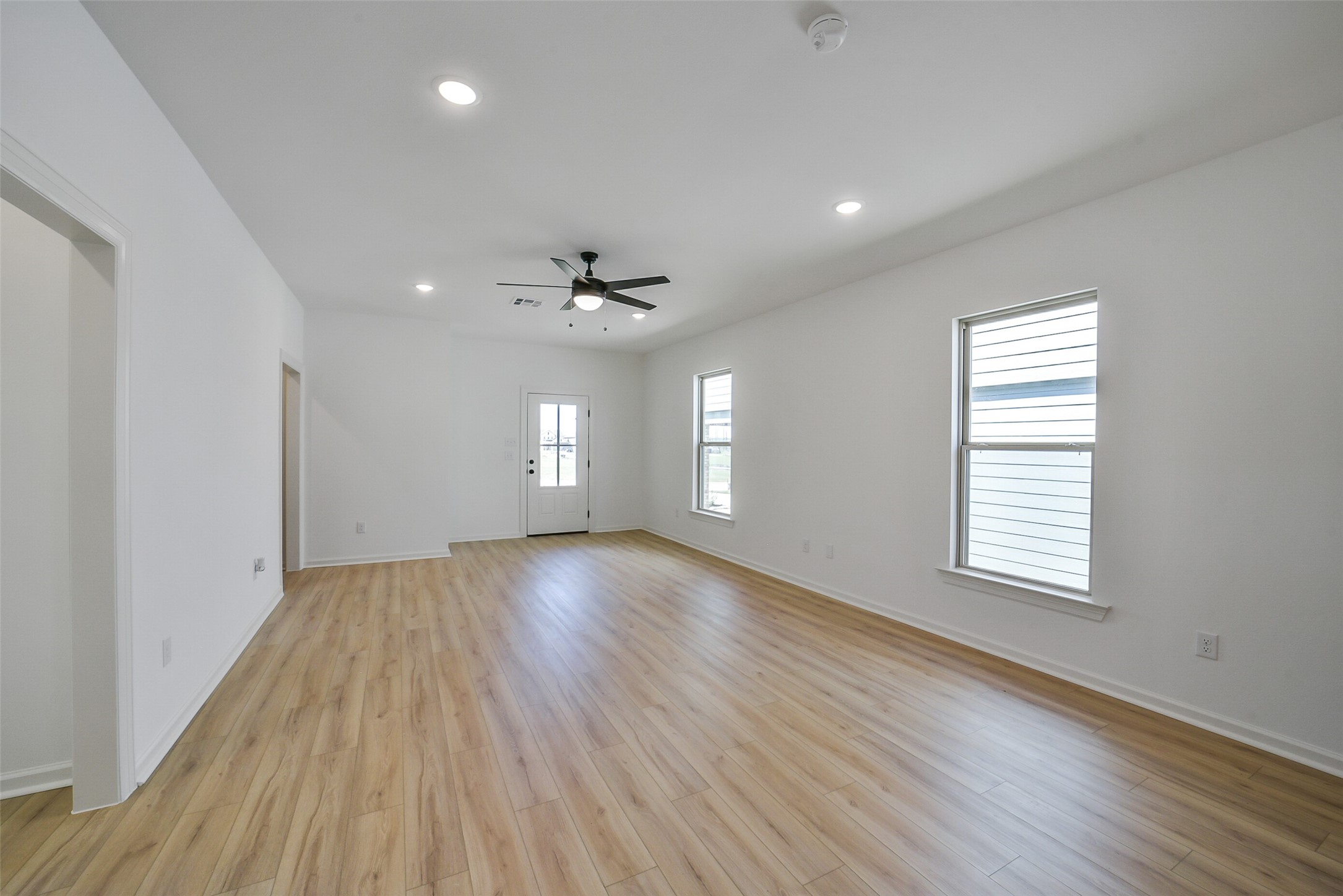 40708 Pessi Road Magnolia, TX 77354 - Photo 12 of 30 an empty room with wooden floor and windows