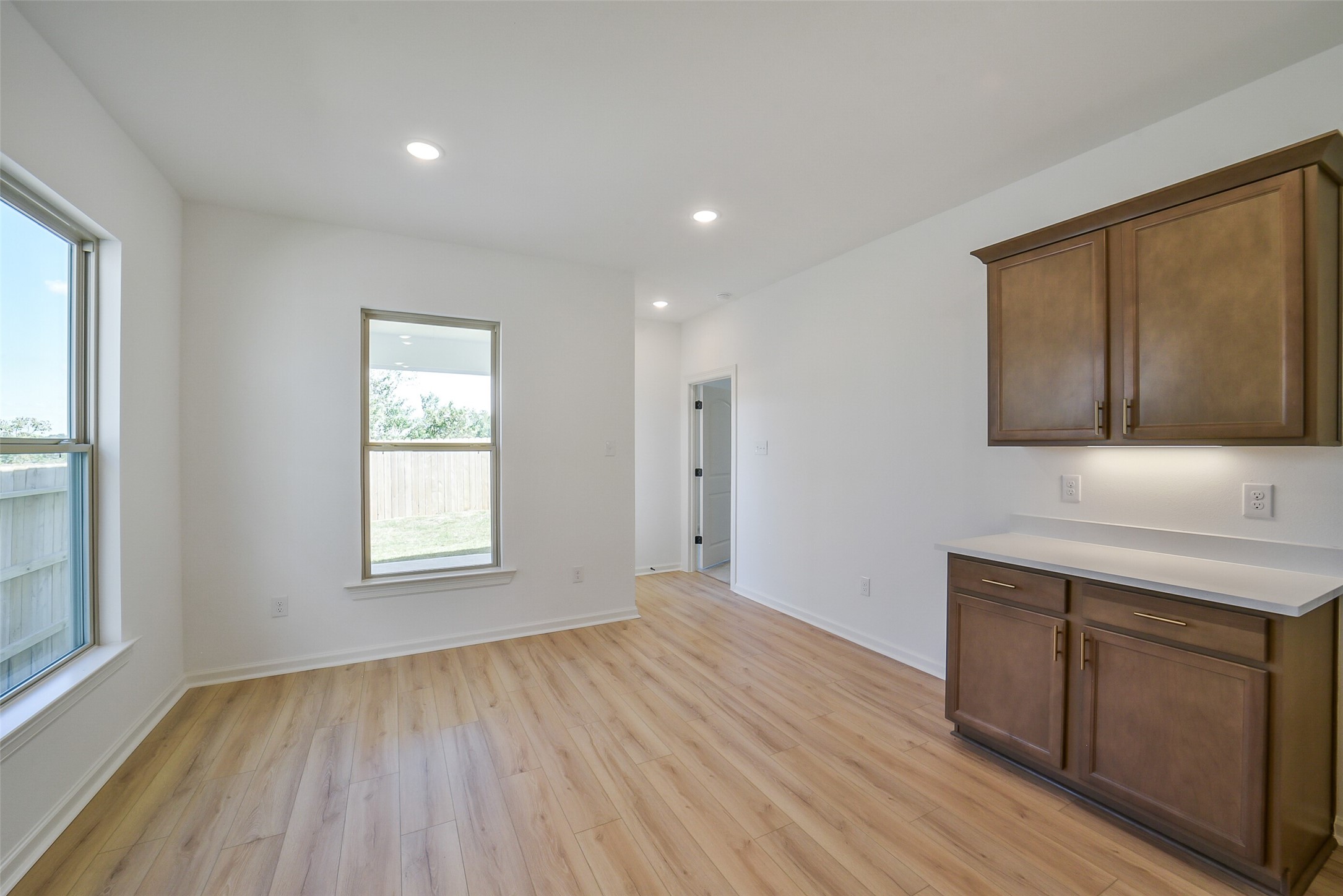 40708 Pessi Road Magnolia, TX 77354 - Photo 13 of 30 a view of an empty room with wooden floor and a window