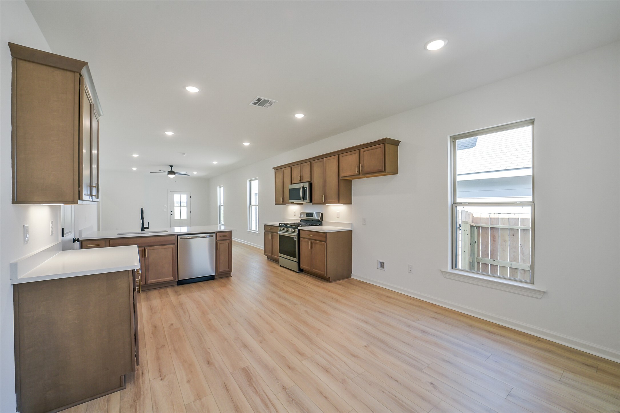 40708 Pessi Road Magnolia, TX 77354 - Photo 14 of 30 a large kitchen with stainless steel appliances refrigerator sink and cabinets