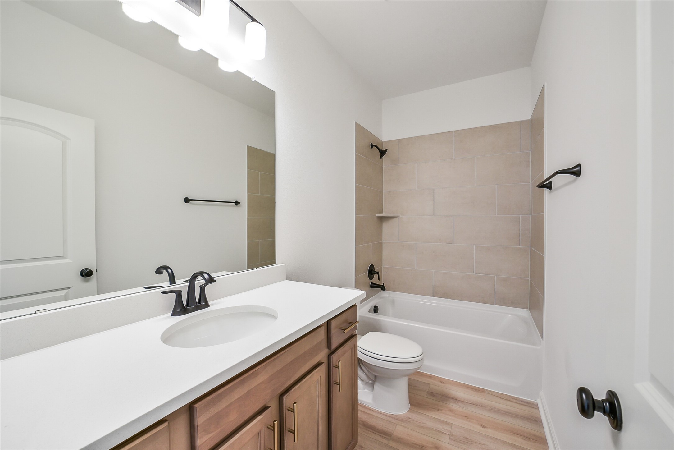 40708 Pessi Road Magnolia, TX 77354 - Photo 25 of 30 a bathroom with a sink a toilet and a large mirror