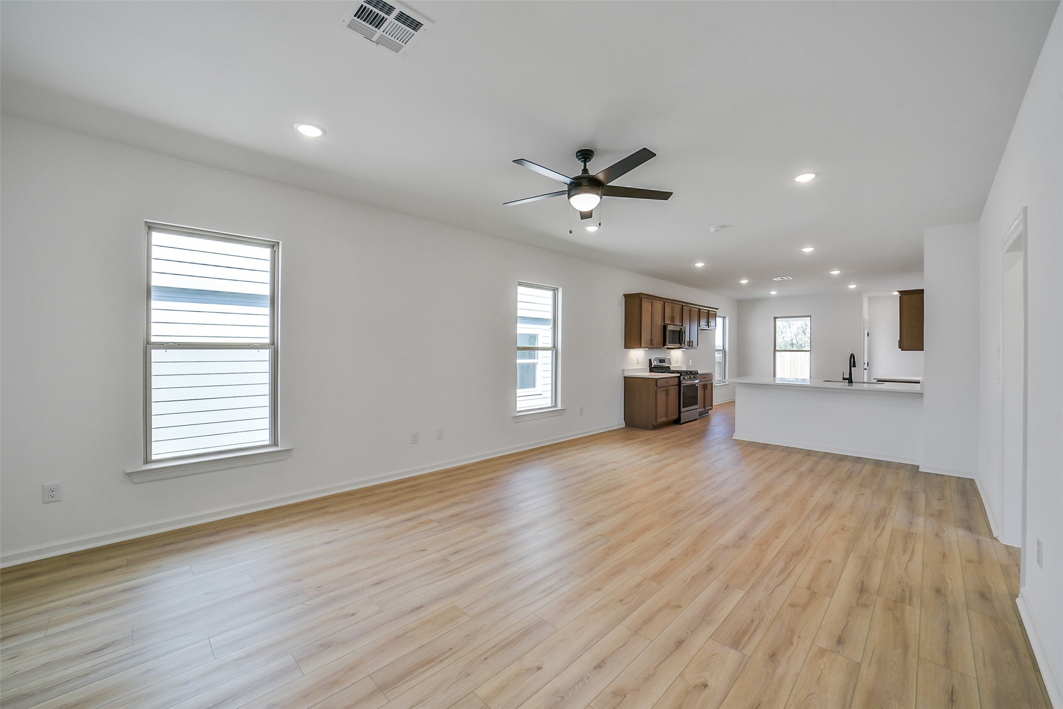 40708 Pessi Road Magnolia, TX 77354 - Photo 7 of 30 a view of an empty room with a window and wooden floor