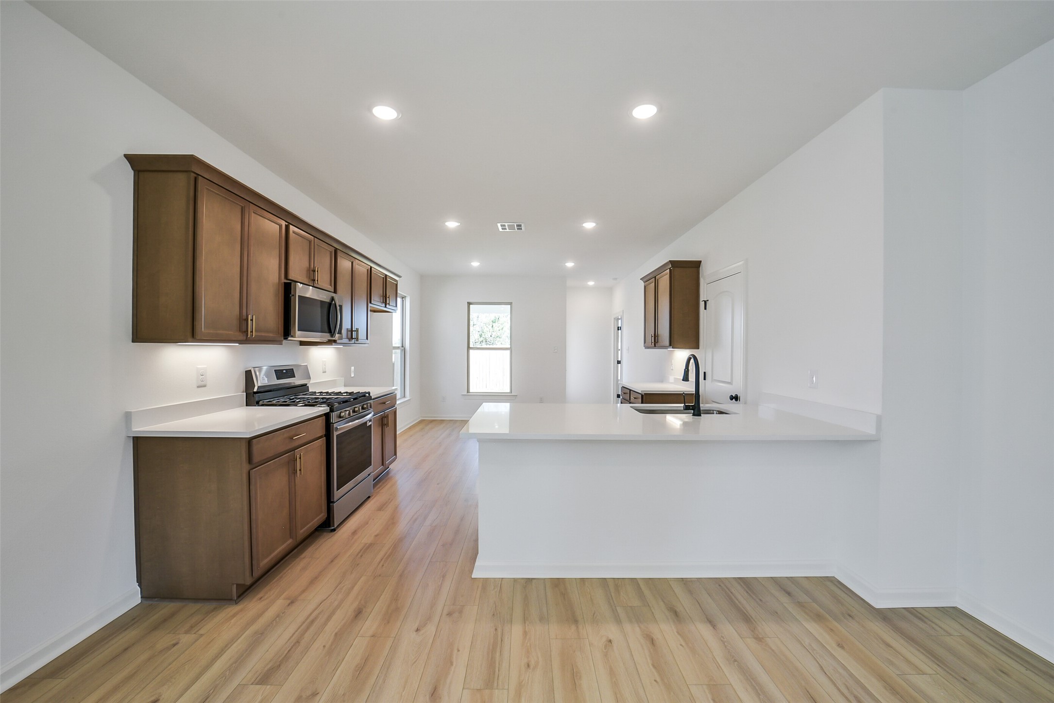 40708 Pessi Road Magnolia, TX 77354 - Photo 8 of 30 a large kitchen with stainless steel appliances granite countertop a lot of counter space and wooden floor