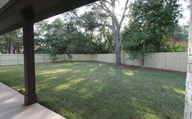 a view of a backyard with large trees