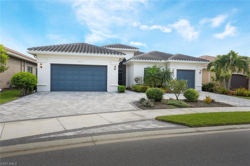 4609 Azalea Drive Naples, FL 34119 - Photo 2 of 45 a front view of a house with garden