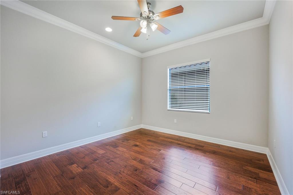 4609 Azalea Drive Naples, FL 34119 - Photo 24 of 45 a view of an empty room with window and wooden floor