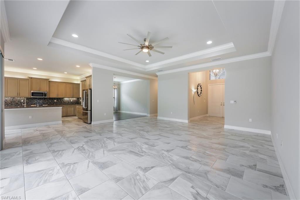 4609 Azalea Drive Naples, FL 34119 - Photo 6 of 45 a view of a kitchen with a refrigerator and a stove top oven