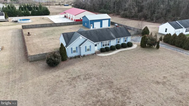 a view of a house with a yard and sitting area