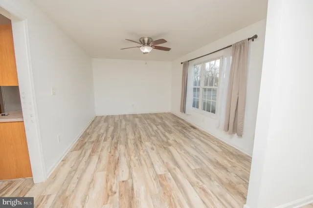 a kitchen with stainless steel appliances granite countertop a refrigerator a stove top oven a sink dishwasher and wooden floor