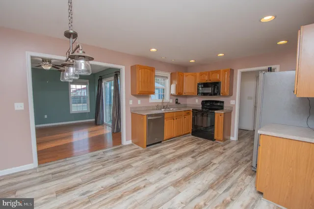 a view of a kitchen with a sink and a refrigerator