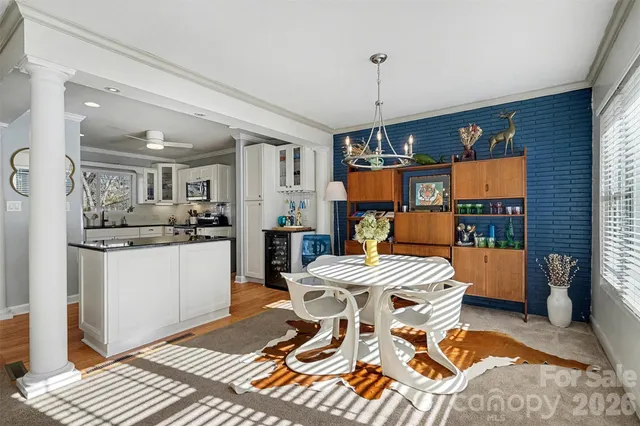 a view of a dining room with furniture and chandelier