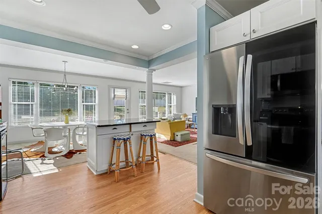 a view of a kitchen with dining table and stainless steel appliances