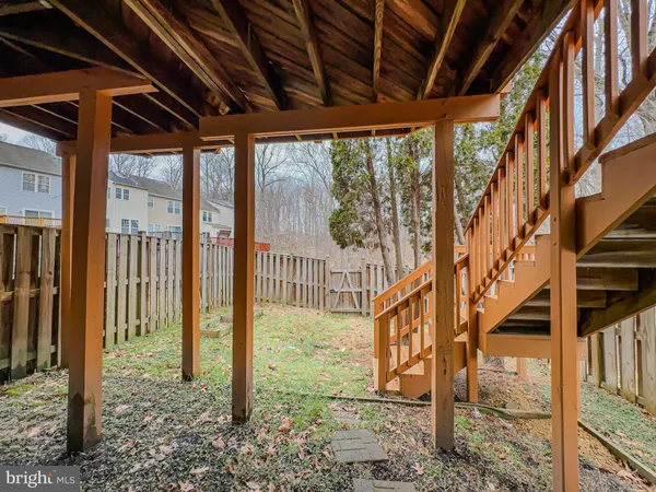 a view of a yard with wooden fence