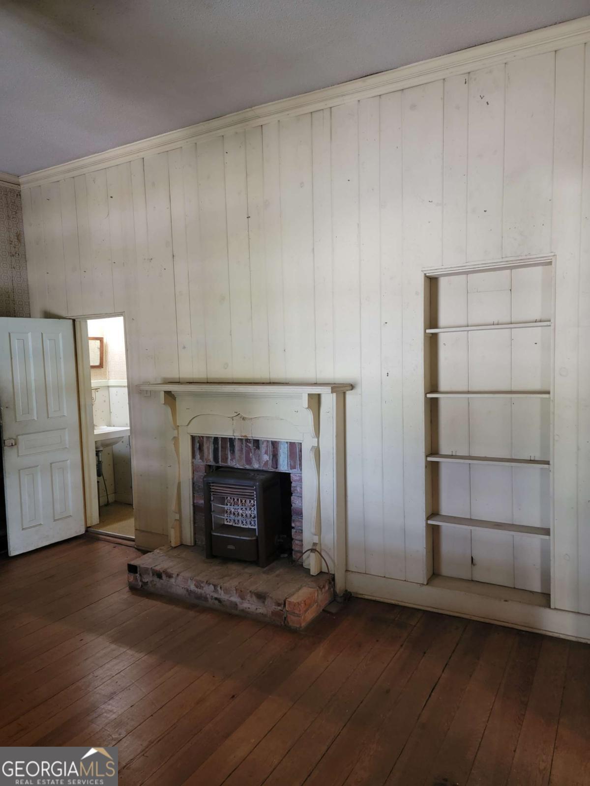 346 South Oliver Street Elberton, GA 30635 - Photo 11 of 52 a room with fireplace and a wooden floor