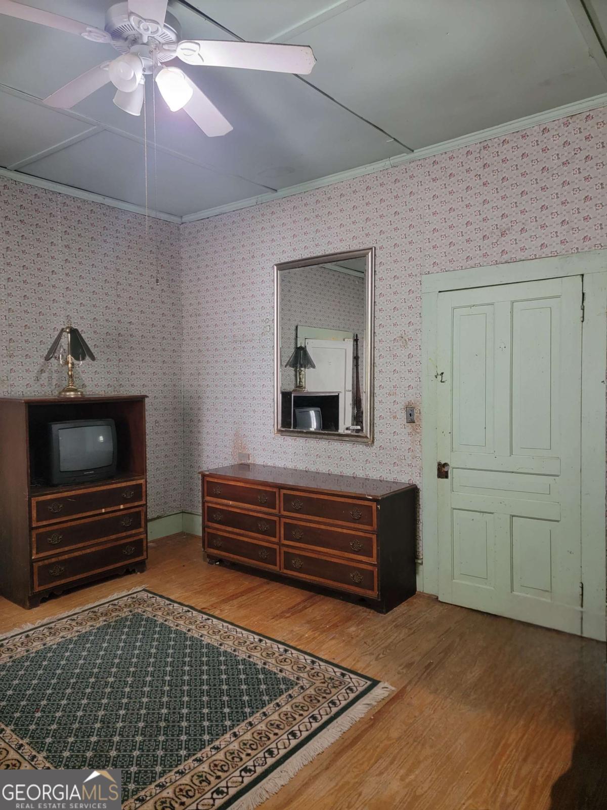 346 South Oliver Street Elberton, GA 30635 - Photo 28 of 52 a bedroom with a bed and a chandelier