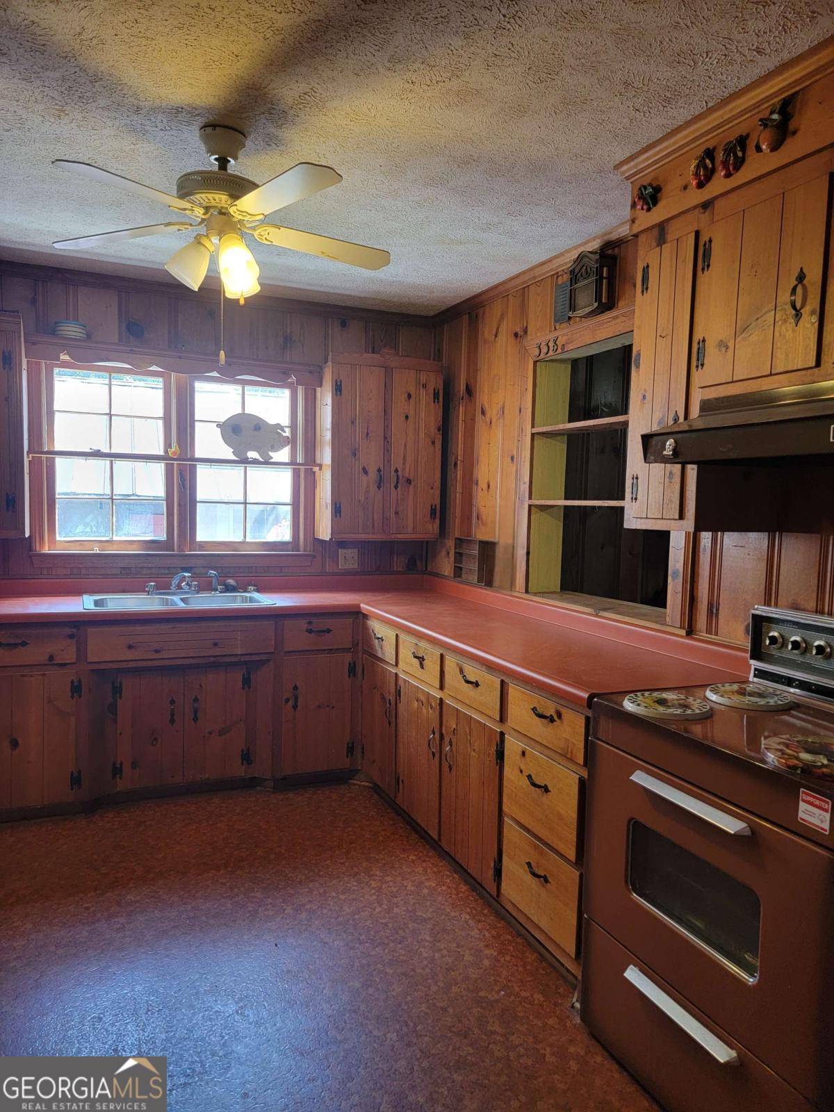 346 South Oliver Street Elberton, GA 30635 - Photo 40 of 52 a kitchen with stainless steel appliances granite countertop a stove a sink and a microwave